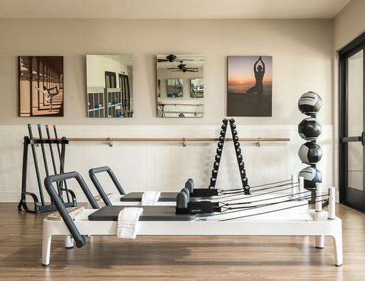 Home wellness space featuring a Pilates reformer and sauna for fitness and relaxation