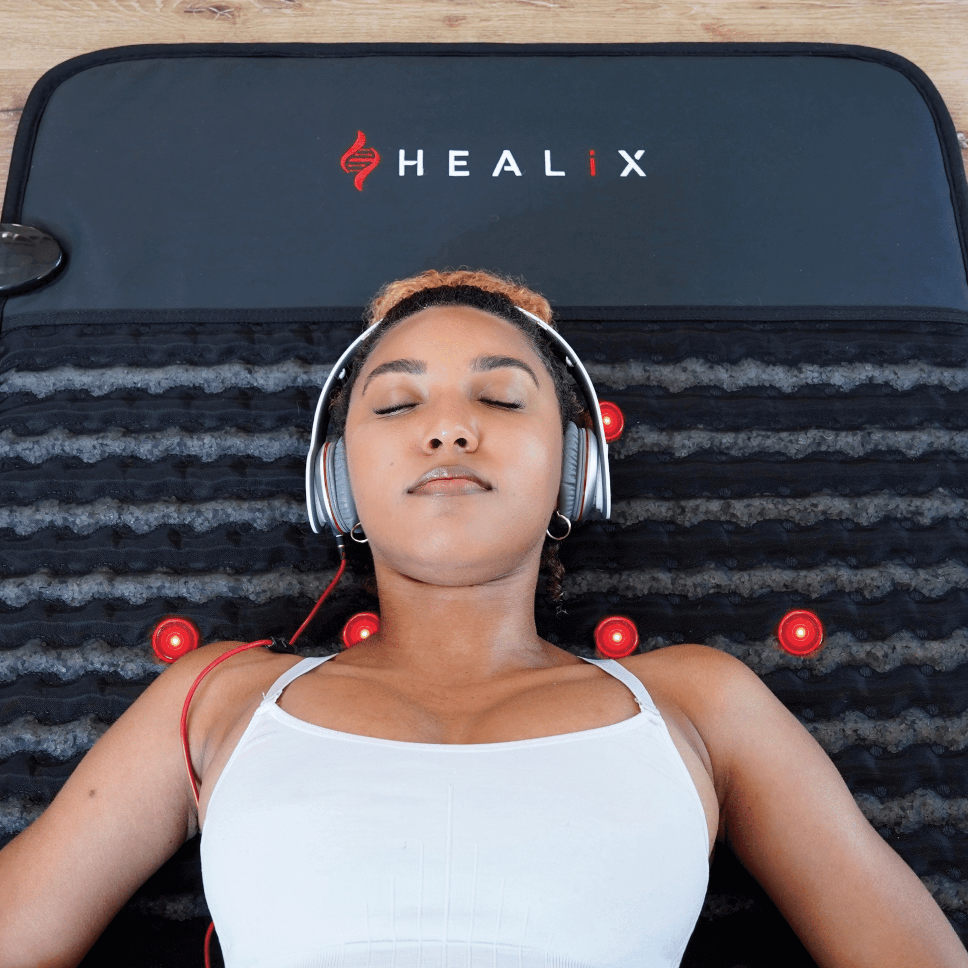Person using HEALiX Revive mat at home for relaxation