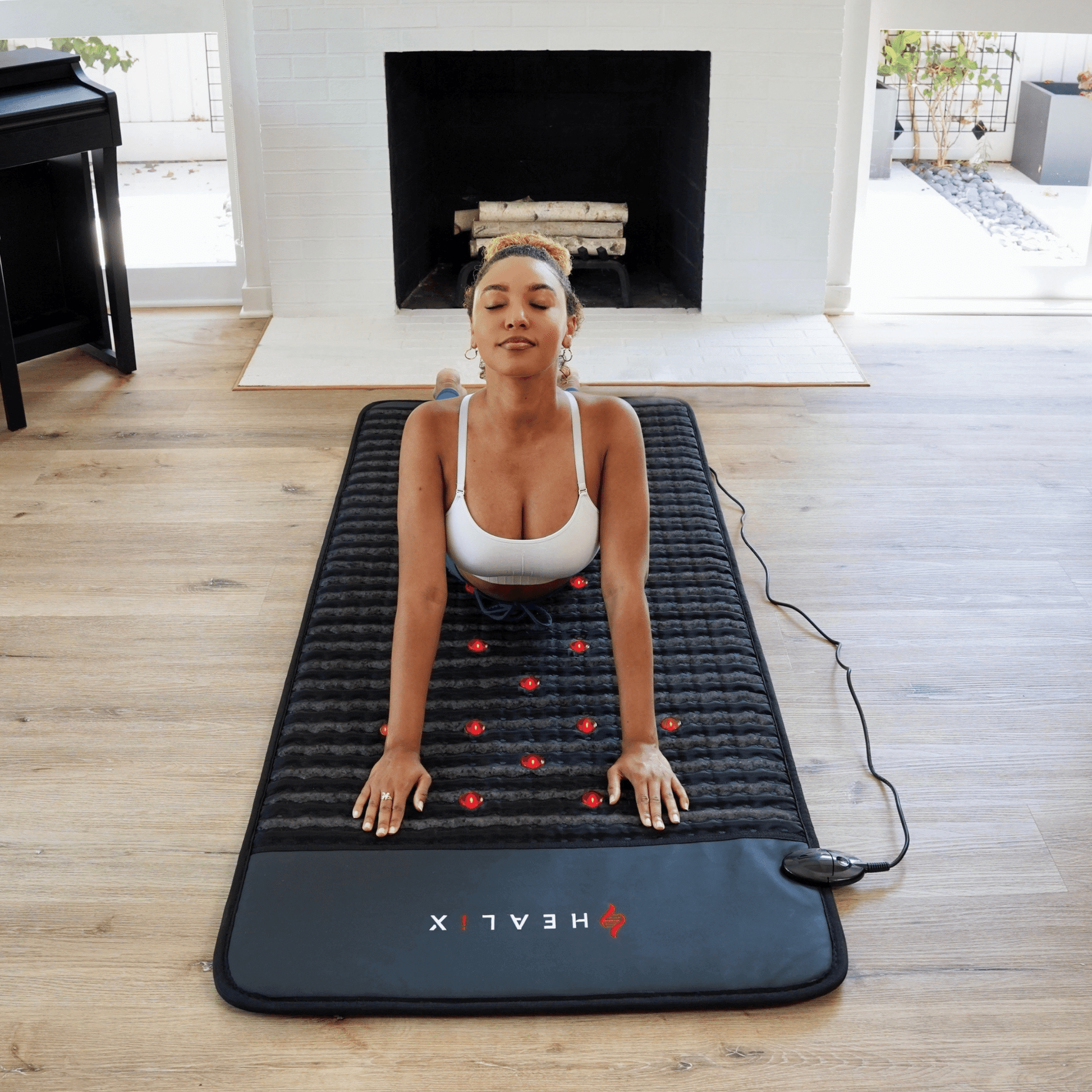 Person using HEALiX Revive mat at home for relaxation