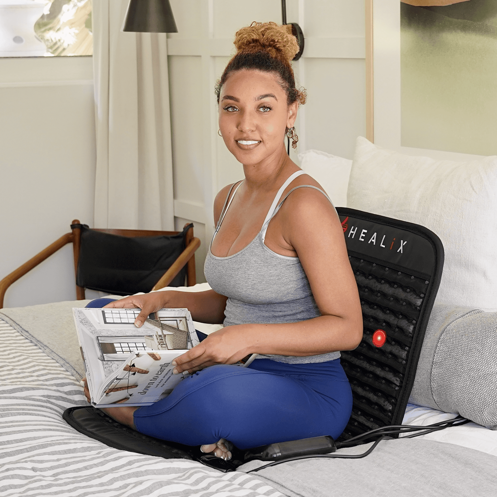 Person relaxing on HEALiX Revive Mini Infrared Mat – portable PEMF therapy for home wellness
