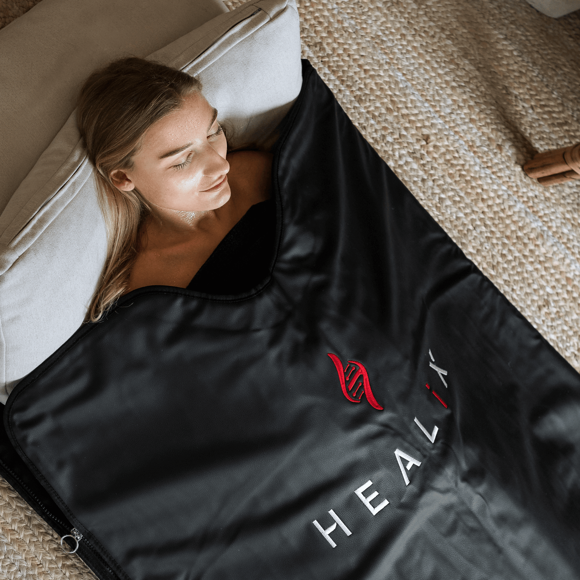 Person relaxing in HEALiX-Z Sauna Blanket at home