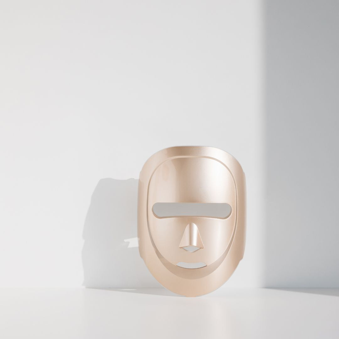 Gold mask-shaped device on a white background