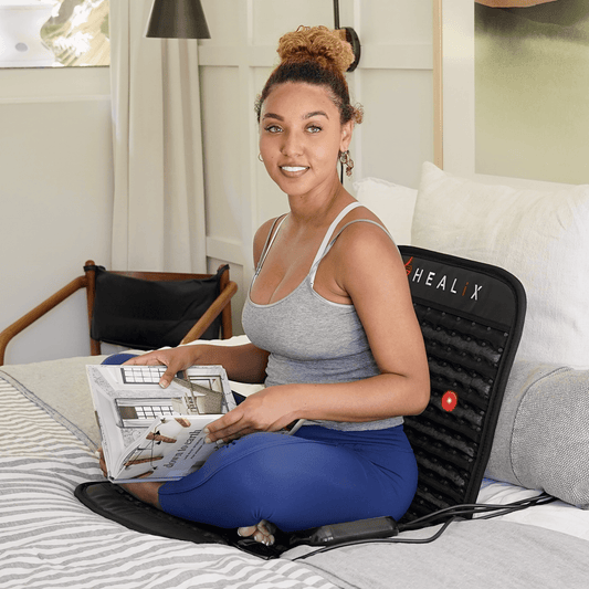Person relaxing on HEALiX Revive Mini Infrared Mat – portable PEMF therapy for home wellness