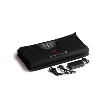 Black mat with a power adapter and cable on a white background