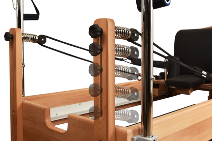 Wooden exercise machine with springs and metal components on a white background