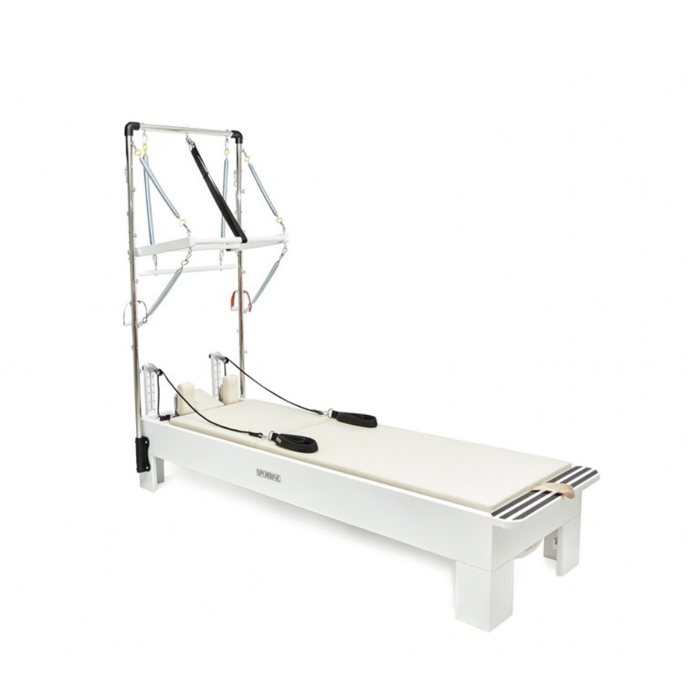 White reformer bed with metal frame on a white background