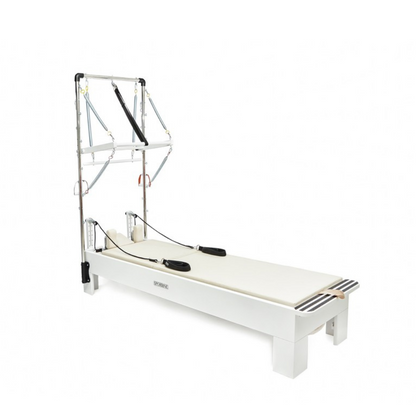 White reformer bed with metal frame on a white background