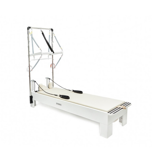 White reformer bed with metal frame on a white background