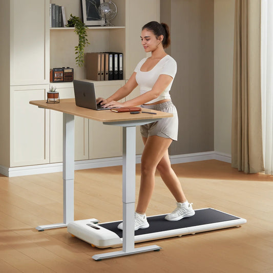 Woman using walkingpad-c2 under desk in a home office setting